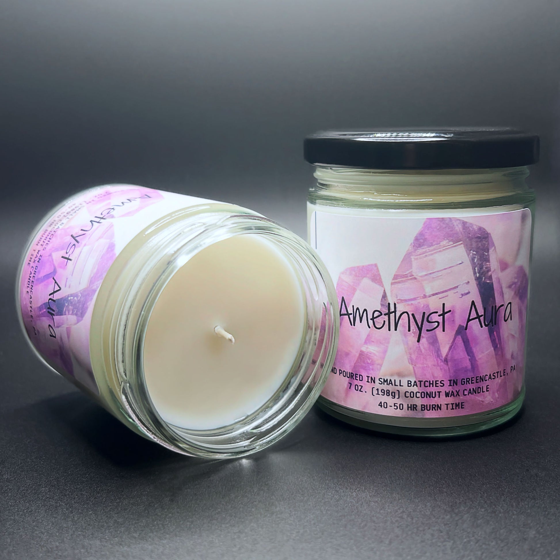 Top view of open Amethyst Aura candle, white wax, label visible.