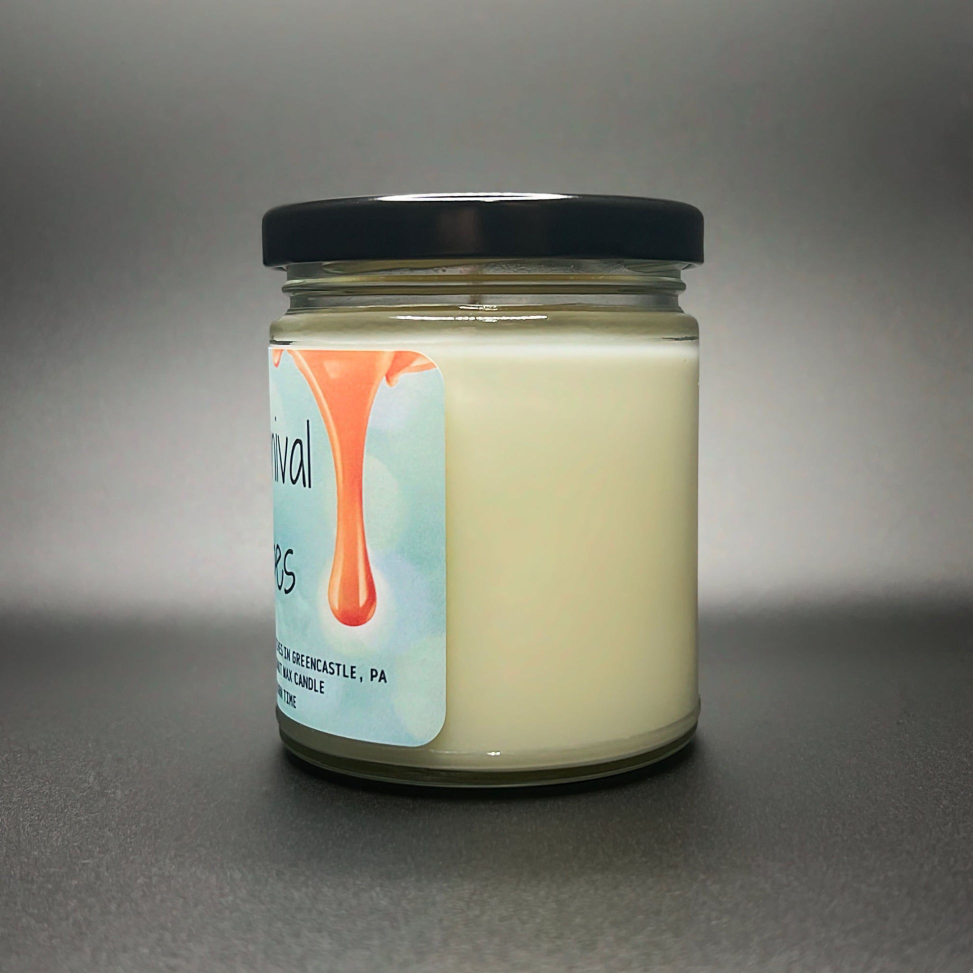 Angled view of Carnival Vibes coconut soy wax candle highlighting the creamy texture.