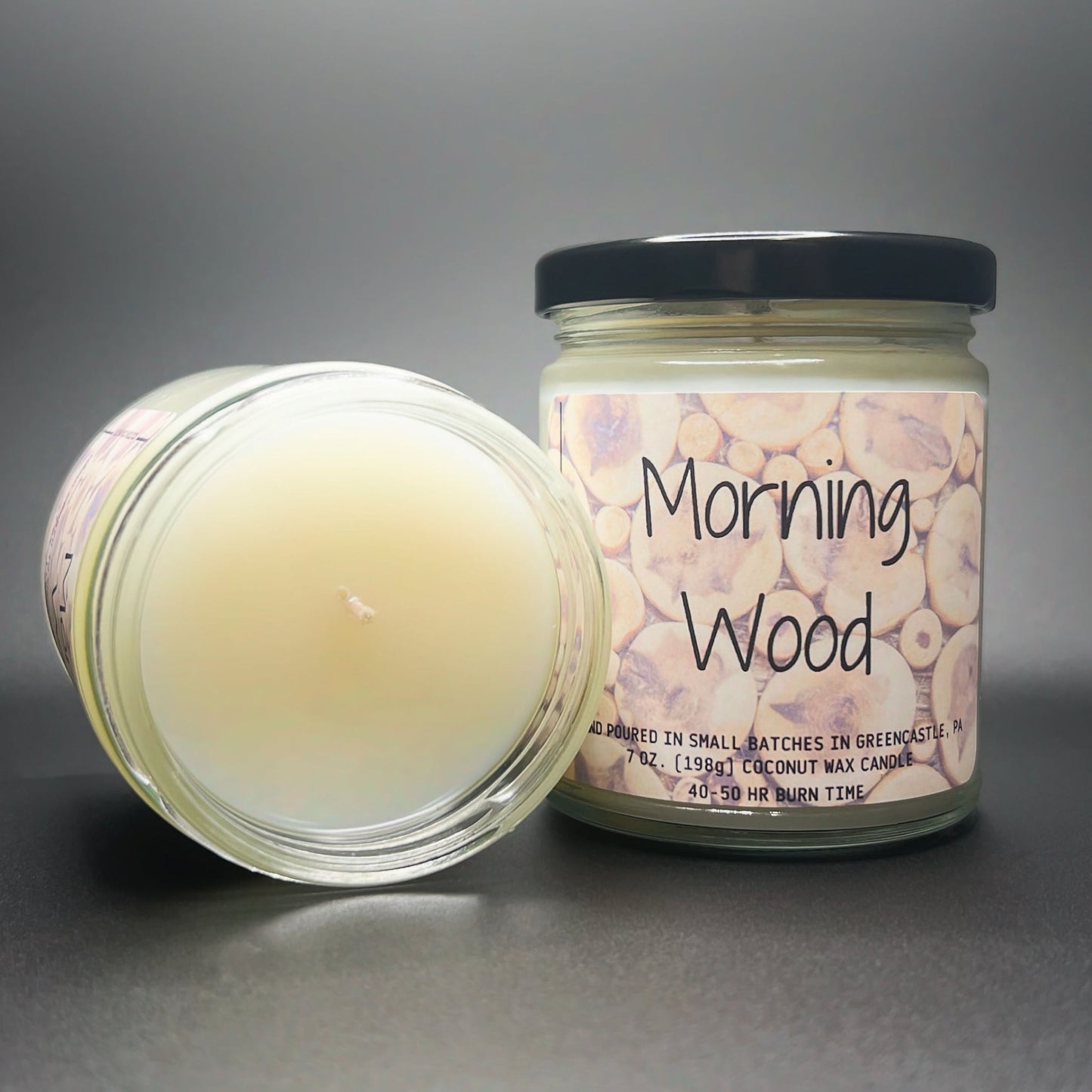 Open jar view of Elysium Candle Co.’s Morning Wood, showing the creamy coconut soy blend wax, with a label featuring a rustic wood slice design for a natural appeal.