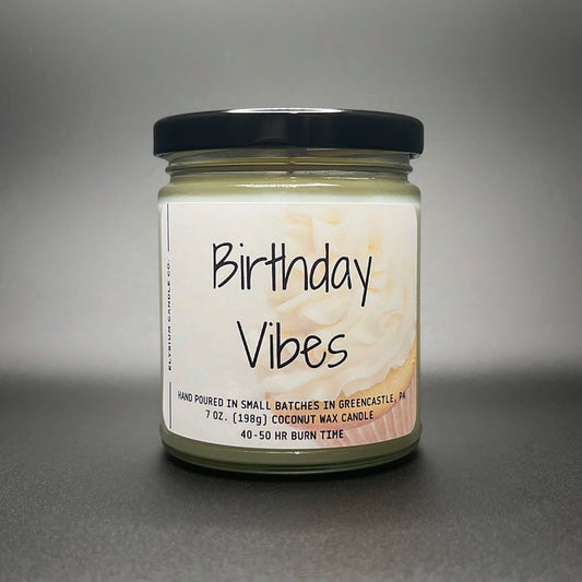 A 7 oz ‘Birthday Vibes’ candle by Elysium Candle Co., featuring a creamy coconut soy wax blend and a joyful label with a marble cake swirl design