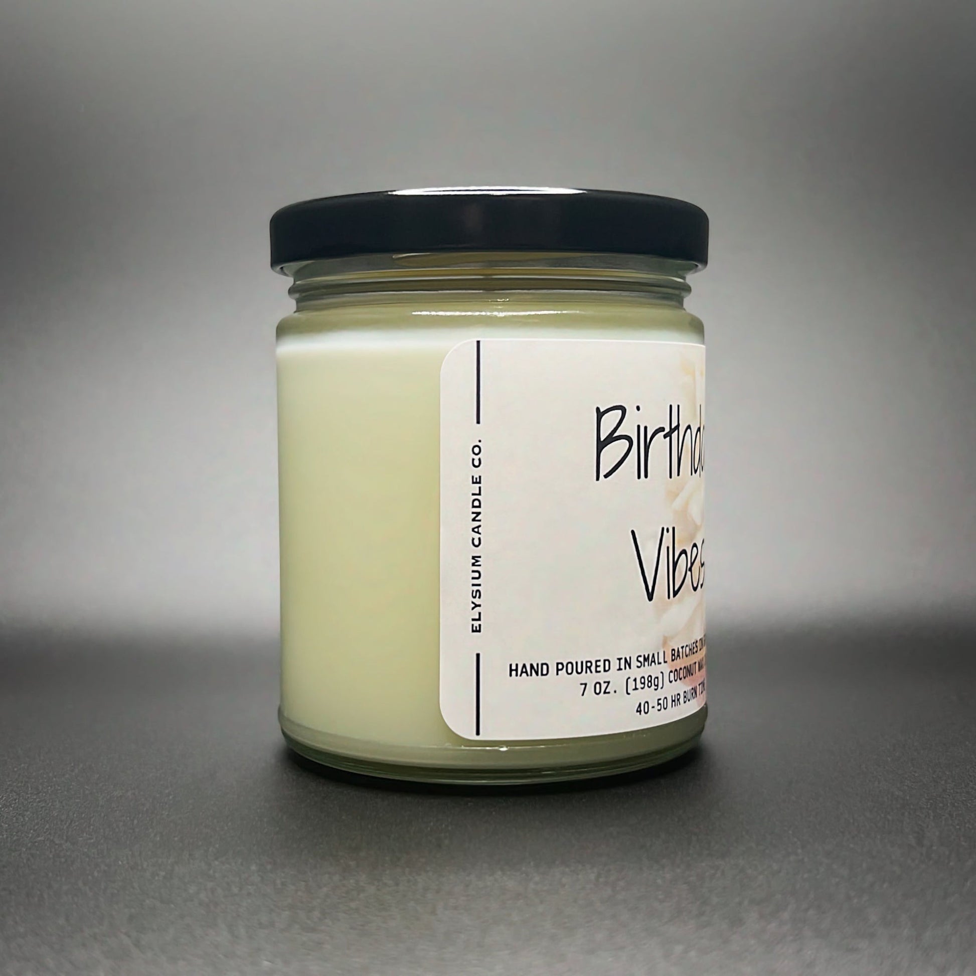 Side view of the Birthday Vibes candle, showcasing the pure and natural coconut soy wax blend in Elysium Candle Co.’s signature 7 oz jar.