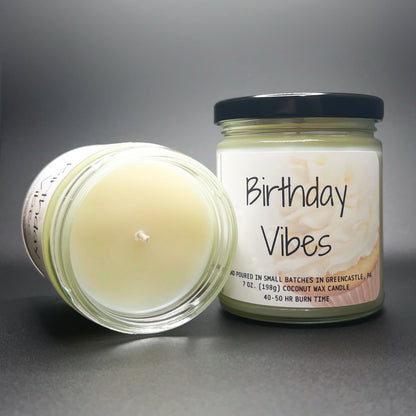 Open jar view of Elysium’s Birthday Vibes candle, emphasizing the smooth coconut soy wax and a festive cake-inspired label, perfect for gifting