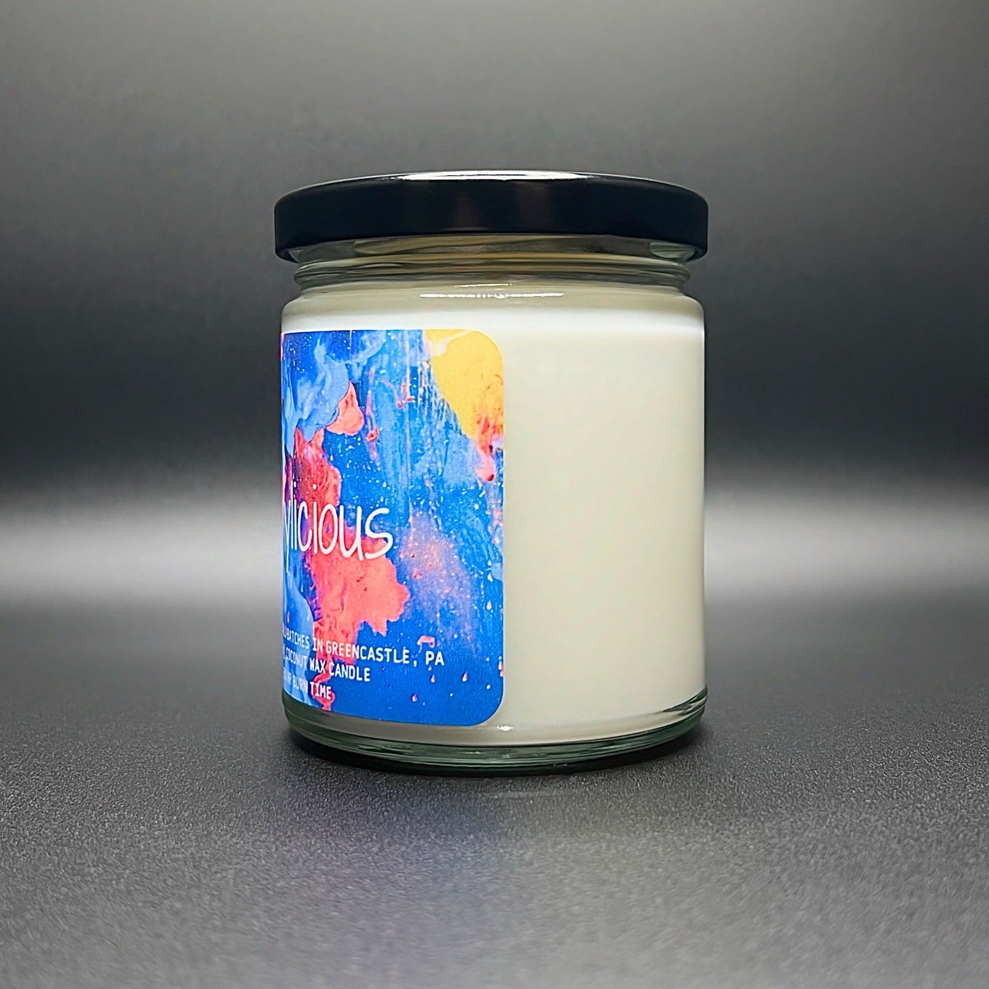 Frontal view of the Brrylicious candle, exhibiting the striking label art with bold colors, encapsulating the coconut soy wax blend’s quality.