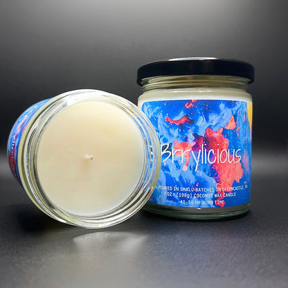 Open jar view of the Brrylicious candle, highlighting the smooth coconut soy wax and the art-inspired label that radiates a burst of berry tones.