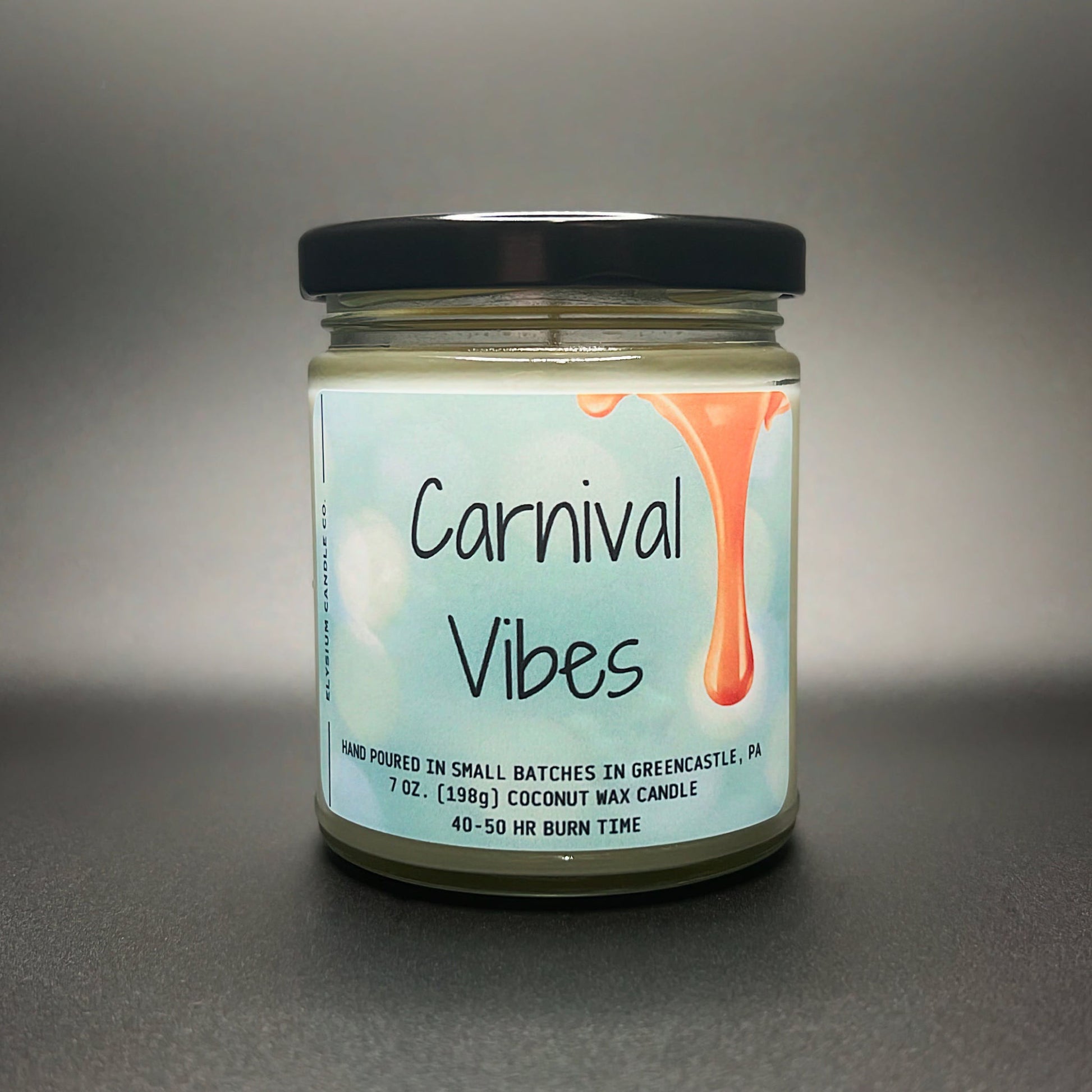Front view of Carnival Vibes coconut soy wax candle by Elysium Candle Co with 40-50 hour burn time label.