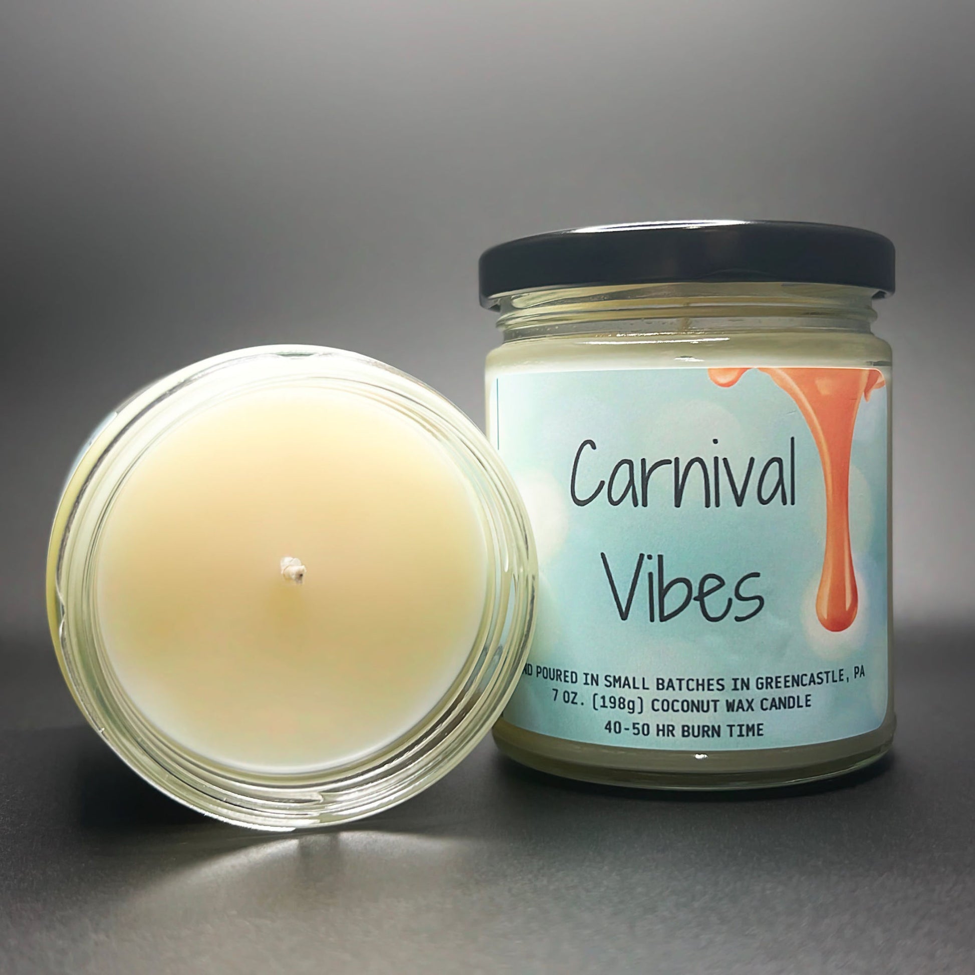 Top view of lit Carnival Vibes scented coconut soy wax candle.