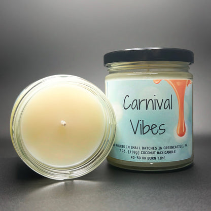 Top view of lit Carnival Vibes scented coconut soy wax candle.