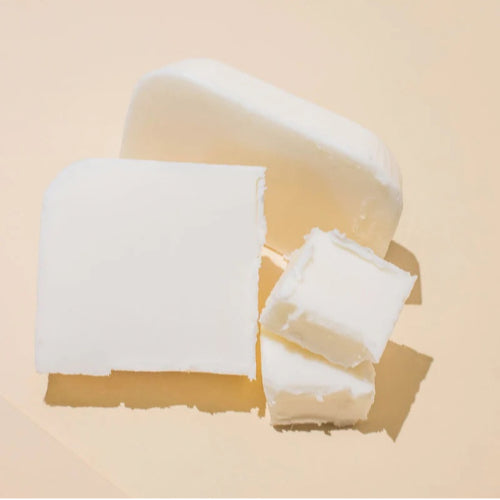 A neatly cut slab of coconut soy wax displayed in natural light, showcasing the raw material used for crafting eco-friendly and vegan candles and wax melts