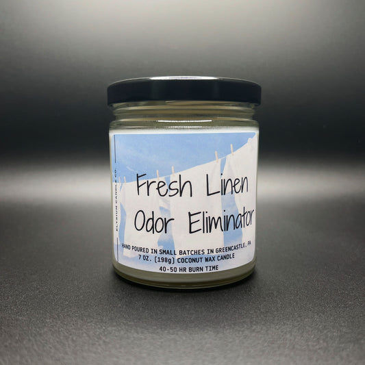 Frontal view of a ‘Fresh Linen Odor Eliminator’ candle, emphasizing the clear labeling, the 7 oz size, and the hand-poured in small batches claim for quality assurance.