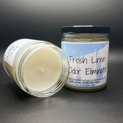 Top view of a ‘Fresh Linen Odor Eliminator’ coconut soy blend candle, with a clean, unburnt wick, showcasing the smooth, creamy texture of the wax and the product label.