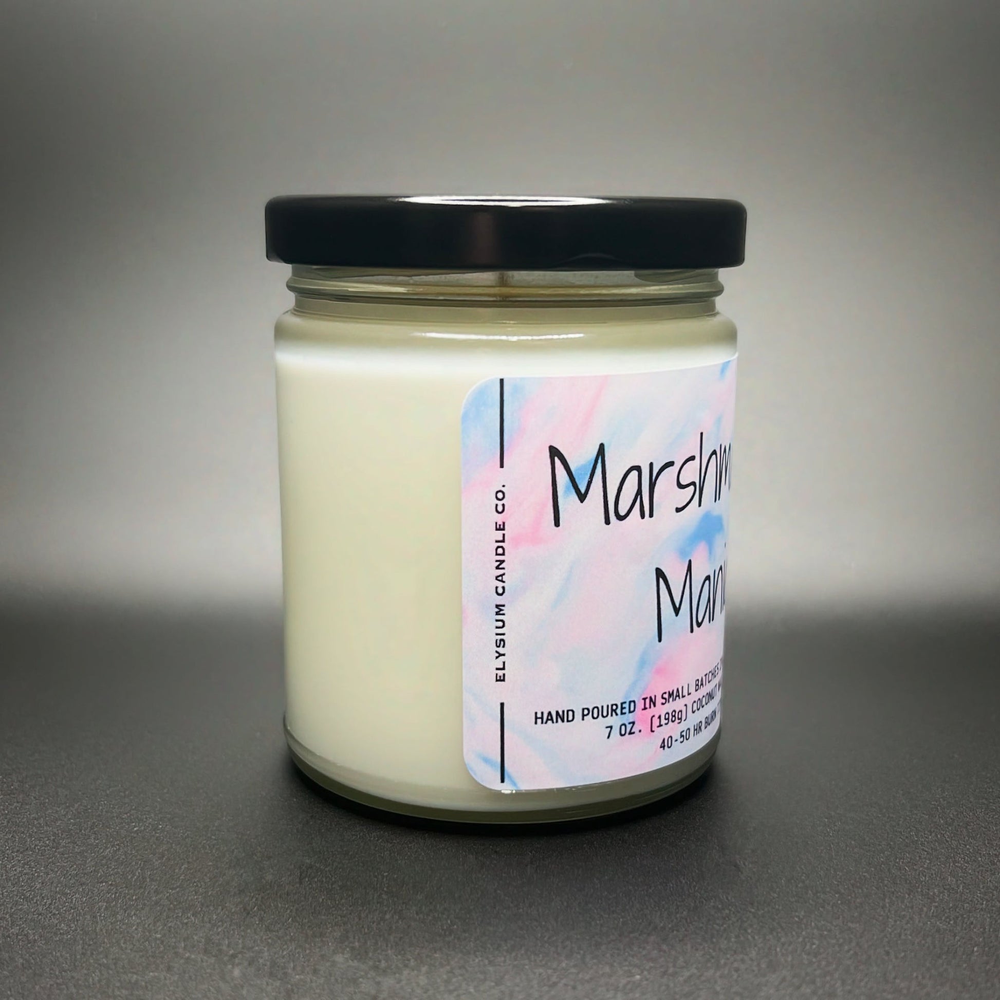 Side view of a 7 oz Marshmallow Mania candle by Elysium Candle Co., featuring a creamy white coconut soy blend wax and a minimalist pastel watercolor design label.