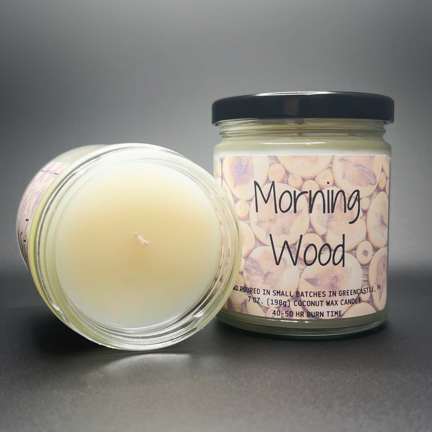 Open jar view of Elysium Candle Co.’s Morning Wood, showing the creamy coconut soy blend wax, with a label featuring a rustic wood slice design for a natural appeal.